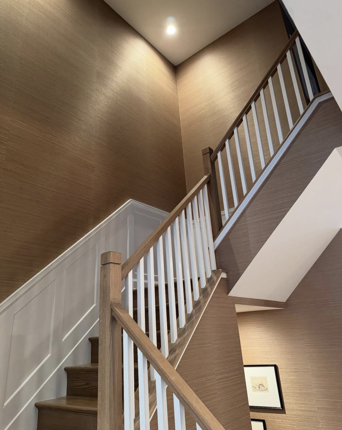 Staircase with textured grasscloth wallpaper